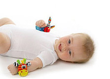 Baby wearing wrist rattles